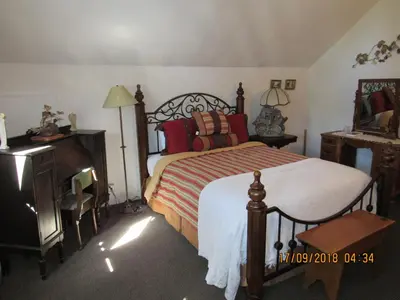a bedroom with a bed and a dresser and a table at Miller's Outpost in Big Bear Lake