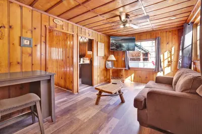 a living room with a couch and a table at Little Pines Couples Lakeside Cabin by Big Bear Vacations in Big Bear Lake