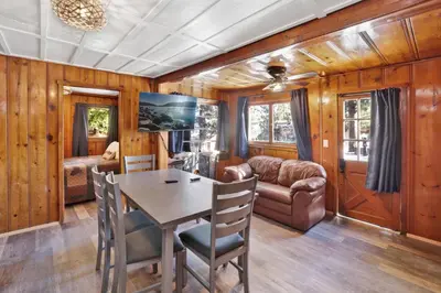 a dining room with a table and a couch at Lakeview Family Cabin by Big Bear Vacations in Big Bear Lake