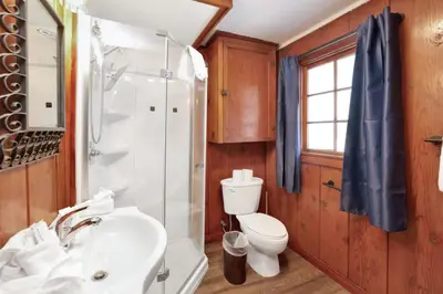 a bathroom with a white sink and a toilet at Lakeview Family Cabin by Big Bear Vacations in Big Bear Lake