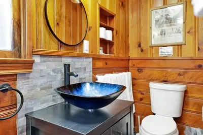 a bathroom with a blue sink and a toilet at Lupine Lakeside Resort Cabin by Big Bear Vacations in Big Bear Lake