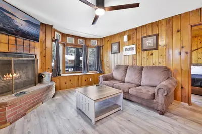a living room with a couch and a fireplace at Lonepine Lakeside Resort Retreat by Big Bear Vacations in Big Bear Lake