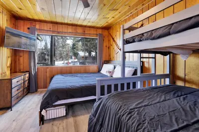 two bunk beds in a room with a window at Lonepine Lakeside Resort Retreat by Big Bear Vacations in Big Bear Lake