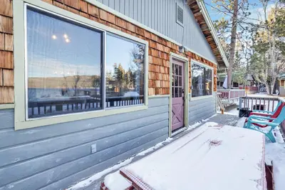 a porch of a house with snow on the ground at Lakefront Family Cabin by Big Bear Vacations in Big Bear Lake