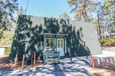 a small house with a shingled roof at Switzerland Ski Chalet-845 by Big Bear Vacations in Big Bear Lake