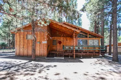 a wooden cabin in the middle of a forest at Avalon Hide Out-1336 by Big Bear Vacations in Big Bear Lake