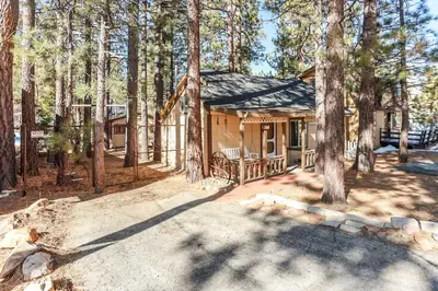 a log cabin in the middle of a forest at Pines 23-1438 by Big Bear Vacations in Big Bear Lake