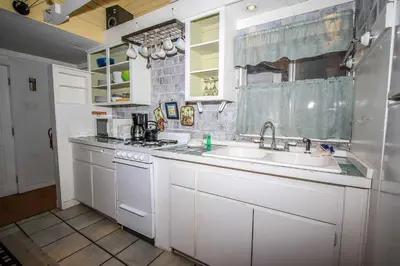 a kitchen with white cabinets and a sink at Pines 23-1438 by Big Bear Vacations in Big Bear Lake
