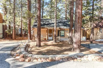 a house in the woods with a lot of trees at Pines 23-1438 by Big Bear Vacations in Big Bear Lake