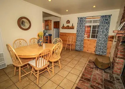 a kitchen and dining room with a table and chairs at Life of Riley-1608 by Big Bear Vacations in Big Bear Lake