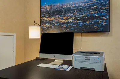 a desk with a computer monitor and a printer at Best Western Diamond Bar Hotel & Suites in Diamond Bar
