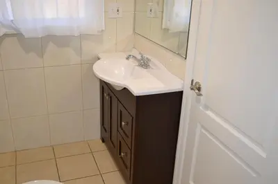 a bathroom with a sink and a mirror at Rex Motel in Ventura