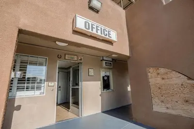 a office sign on the side of a building at Day & Night Inn in Hesperia