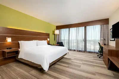 a hotel room with a bed and a television at Holiday Inn Express & Suites Santa Ana - Orange County by IHG in Santa Ana
