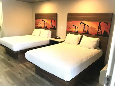 two beds in a hotel room with two beds at Hyland Inn Brea in Brea