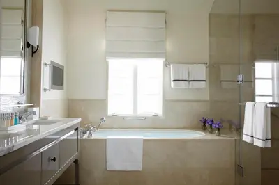 a bathroom with a large tub and a window at Hotel Bel-Air - Dorchester Collection in Los Angeles