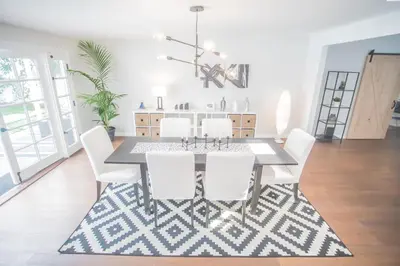 a dining room with a table and white chairs at Enchanting Sherman Oaks Home With Pool permit #HSR two five zero zero 3222 in Sherman Oaks