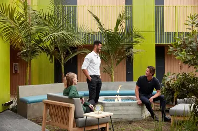 a group of people sitting around a fountain in a courtyard at Mayumi in Los Angeles