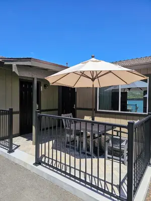 a patio with an umbrella and tables and chairs at Big Bear Frontier in Big Bear Lake