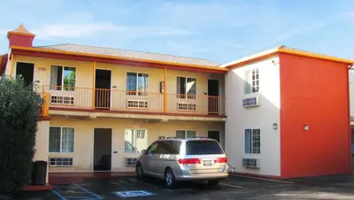a car parked in a parking lot in front of a building at Motel 6 Glendale CA Pasadena Burbank Los Angeles in Glendale