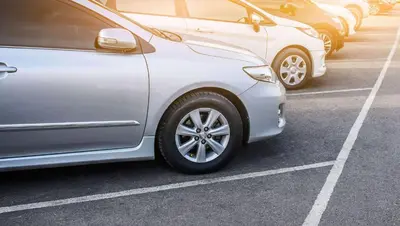 a row of parked cars in a parking lot at Motel 6 Glendale CA Pasadena Burbank Los Angeles in Glendale