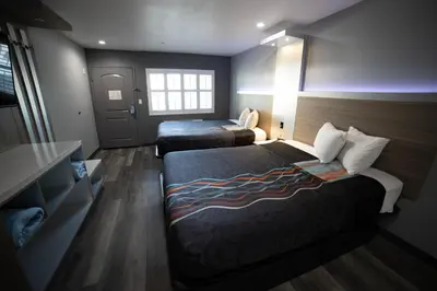 a hotel room with two beds and a window at Travelodge by Wyndham Whittier in Whittier