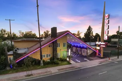 a rendering of a hotel with a neon sign at Sky Palm Motel - Orange in Orange