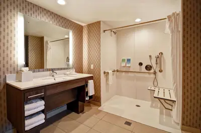 a bathroom with a sink and a shower and a tub at Home2 Suites by Hilton Victorville in Victorville