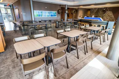 a restaurant with tables and chairs and a bar at SpringHill Suites by Marriott Ontario Airport/Rancho Cucamonga in Ontario