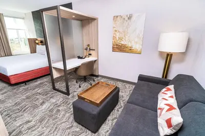 a hotel room with a couch and a bed at SpringHill Suites by Marriott Ontario Airport/Rancho Cucamonga in Ontario