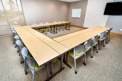 a large conference room with wooden tables and chairs at SpringHill Suites by Marriott Ontario Airport/Rancho Cucamonga in Ontario