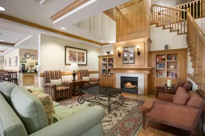 a living room with couches and a fireplace at Holiday Inn & Suites - Barstow by IHG in Barstow