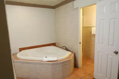 a bathroom with a bath tub in a room at Lambert Inn in Whittier