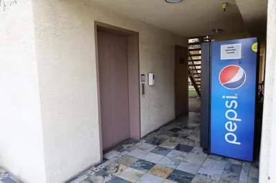 a door to a building with a pepsi sign on it at Lambert Inn in Whittier