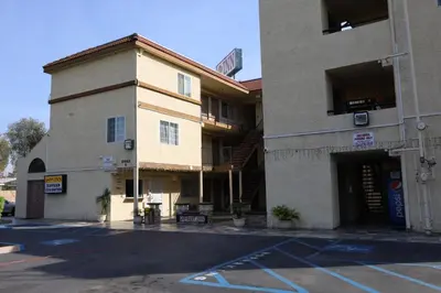 an empty parking lot in front of a building at Lambert Inn in Whittier