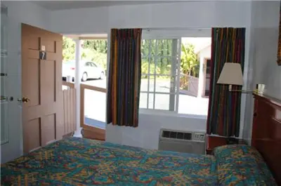 a bedroom with a bed and a large window at Rose Bowl Motel in Los Angeles
