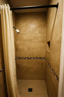 a bathroom with a shower with a shower curtain at Sand Piper Motel - Los Angeles in Los Angeles