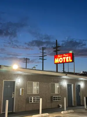 a motel sign on the roof of a building at Sand Piper Motel - Los Angeles in Los Angeles