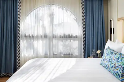 a bedroom with a large bed with a window at The Anza-a Calabasas Hotel in Calabasas