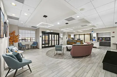a lobby of a hospital with chairs and tables at Homewood Suites Lancaster in Lancaster