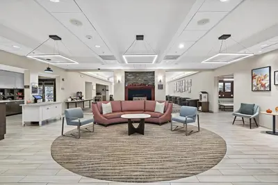 a lobby with a couch and a table and chairs at Homewood Suites Lancaster in Lancaster