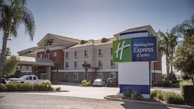 a hotel with a sign in front of a building at Holiday Inn Express Porterville by IHG in Porterville