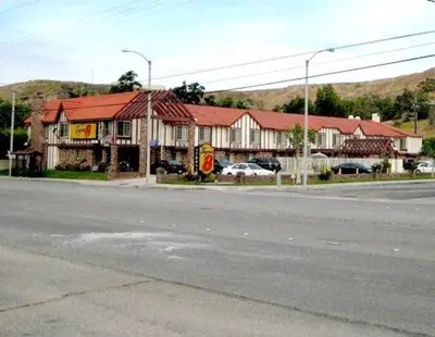 an empty street in a small town with a building at Super 8 by Wyndham Santa Clarita/Valencia in Santa Clarita