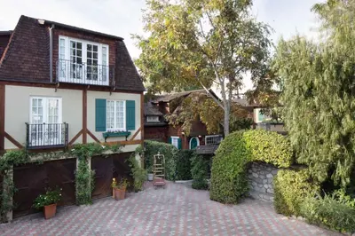 a house with a brick driveway in front of a house at The Charlie West Hollywood in Los Angeles