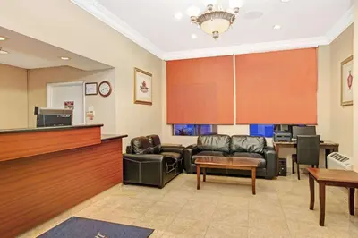 a waiting room with leather couches and a table at Howard Johnson by Wyndham Torrance in Torrance