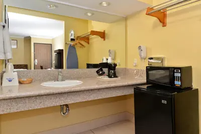a hotel bathroom with a sink and a microwave at Americas Best Value Inn Pasadena in Pasadena