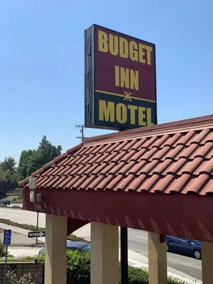a burger inn motel sign on top of a roof at Budget Inn Motel in San Gabriel