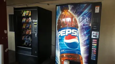 a vending machine with a bottle of energy drink at Budget Inn Motel in San Gabriel