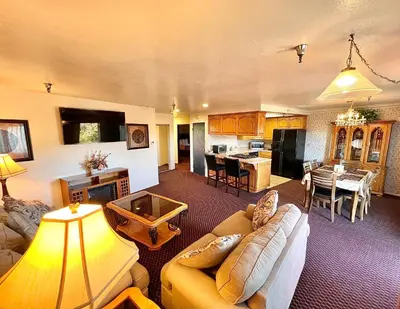 a living room with a couch and a dining room at Oakridge Inn in Oak View