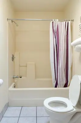 a bathroom with a tub and a toilet and a shower at Mission Motel in Lynwood